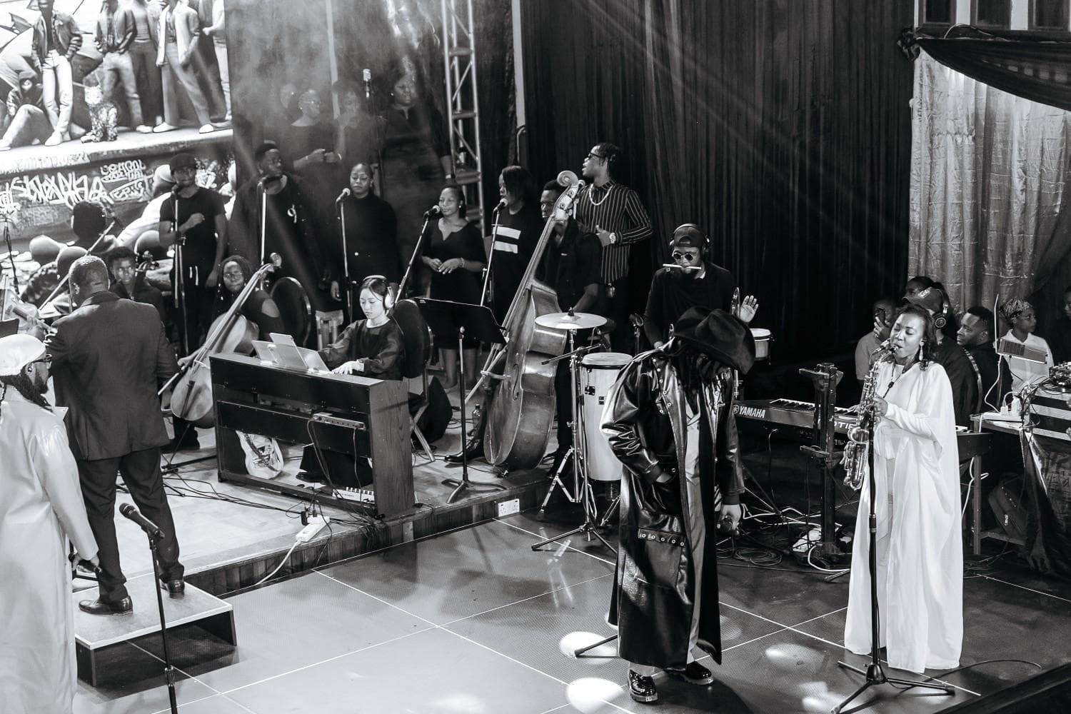 Full Neno Project stage with saxophone, piano, and ensemble