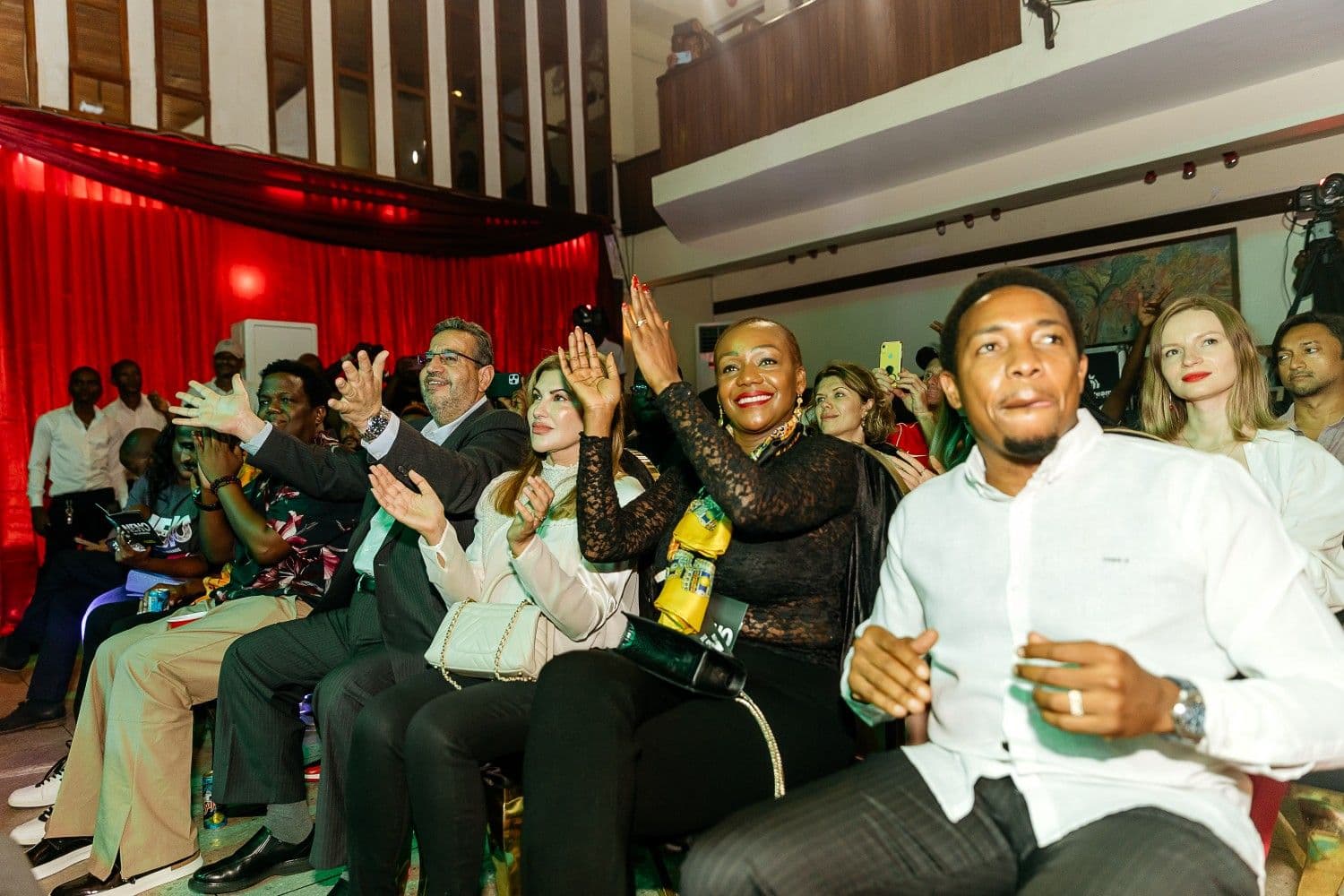 Front-row audience applauding at the Neno Project