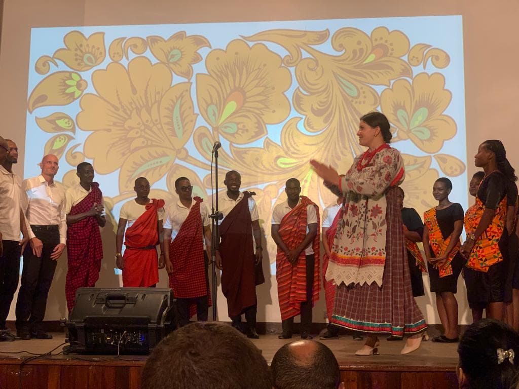 Cultural celebration on stage with Tanzanian and international dress