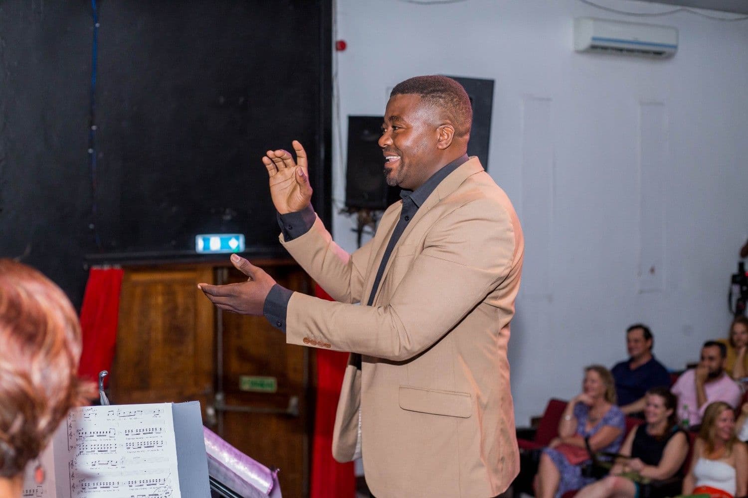 Conductor shaping a phrase during a live performance